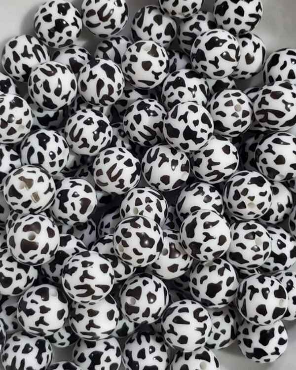 A pile of black and white balls sitting on top of each other.