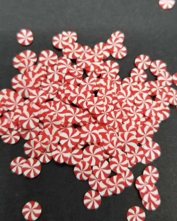 A pile of red and white candy canes on top of each other.