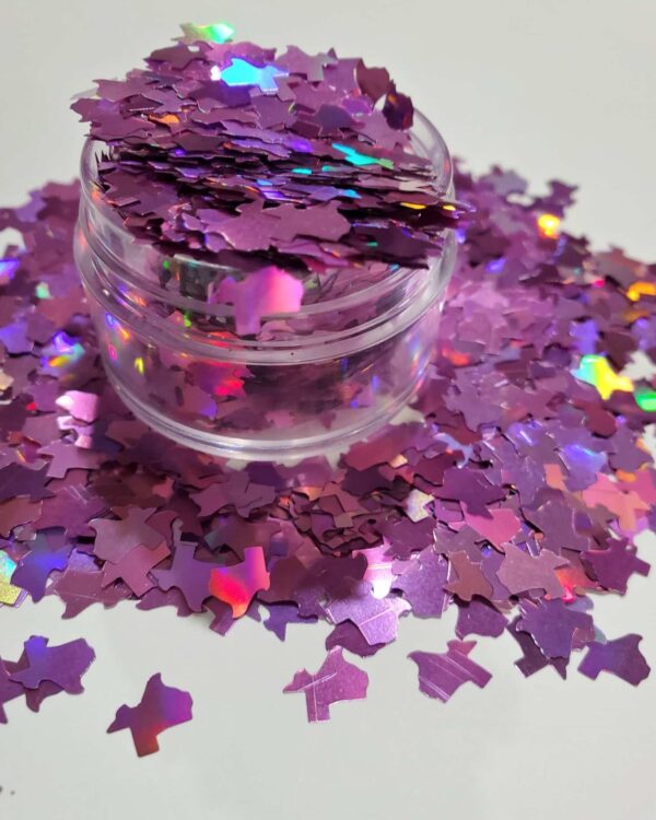 A jar of purple confetti on top of a table.