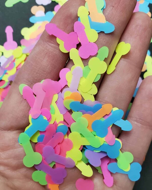 A hand is holding some colorful confetti