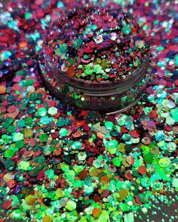 A jar of colorful glitter on top of a table.