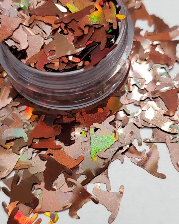 A jar of confetti on top of some pieces of paper.