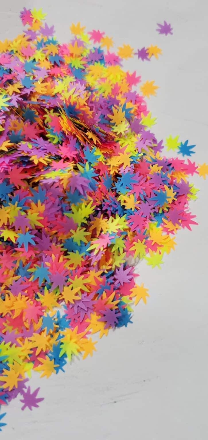 A pile of colorful confetti on top of the floor.