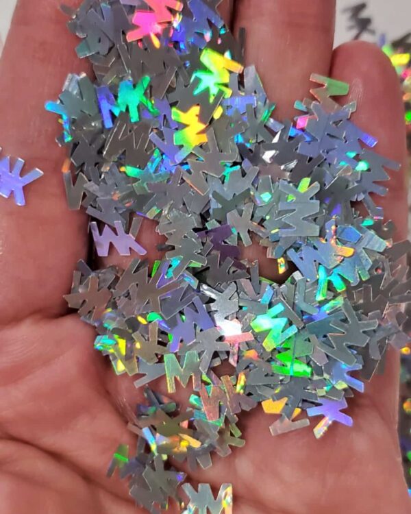 A hand holding some silver confetti in it