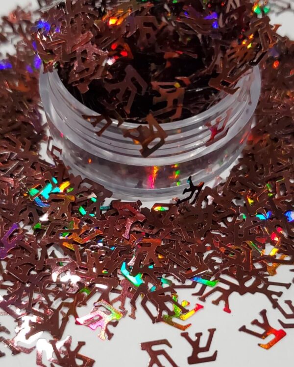 A jar of chocolate sprinkles on top of some brown confetti.