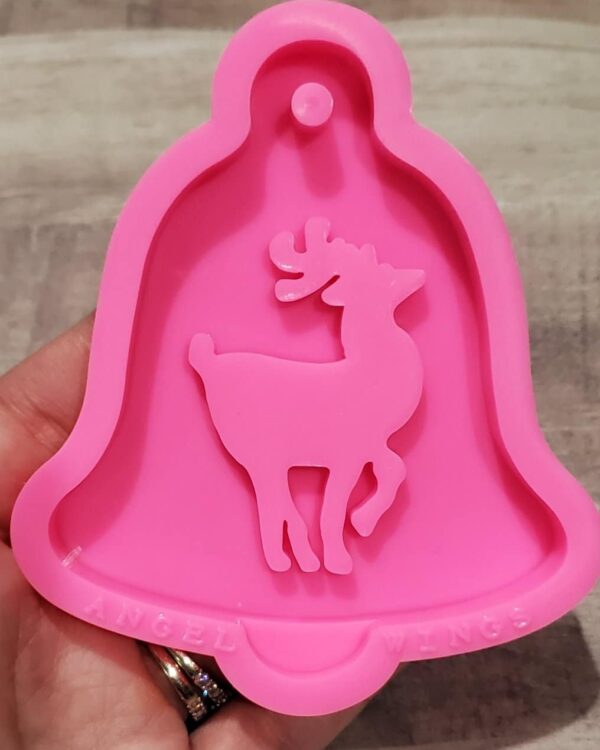 A pink bell shaped mold with a deer on it.