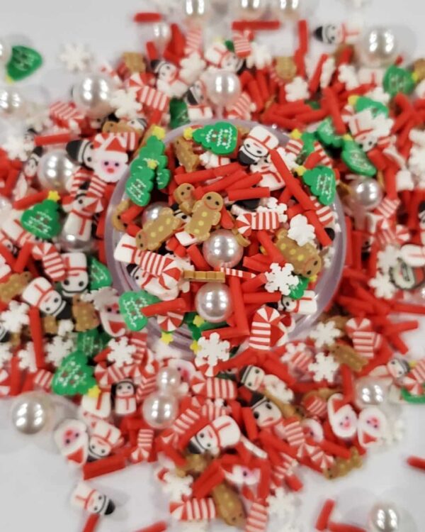 A bowl of christmas sprinkles on top of the table.