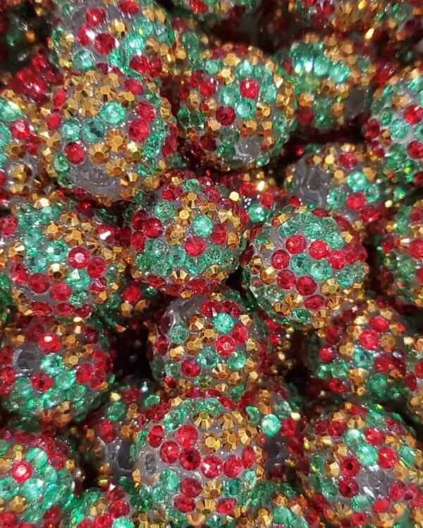 A close up of some balls covered in green and red sprinkles