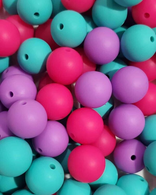 A pile of purple and blue beads sitting next to each other.