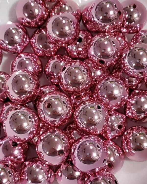 A pile of pink beads sitting on top of each other.