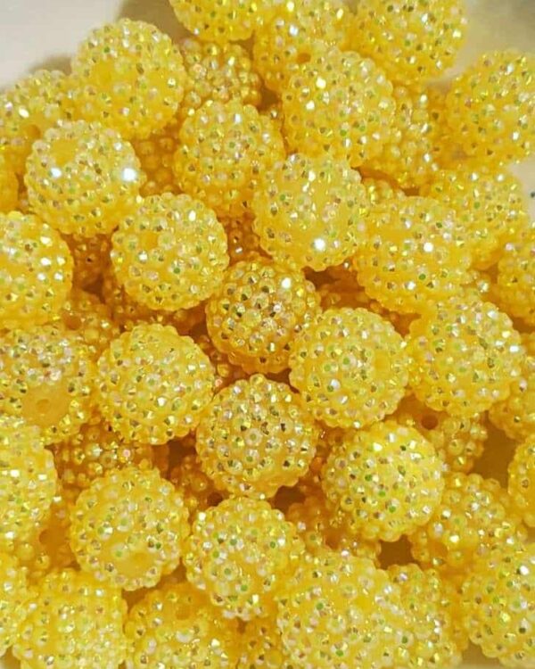 A close up of yellow beads on the table