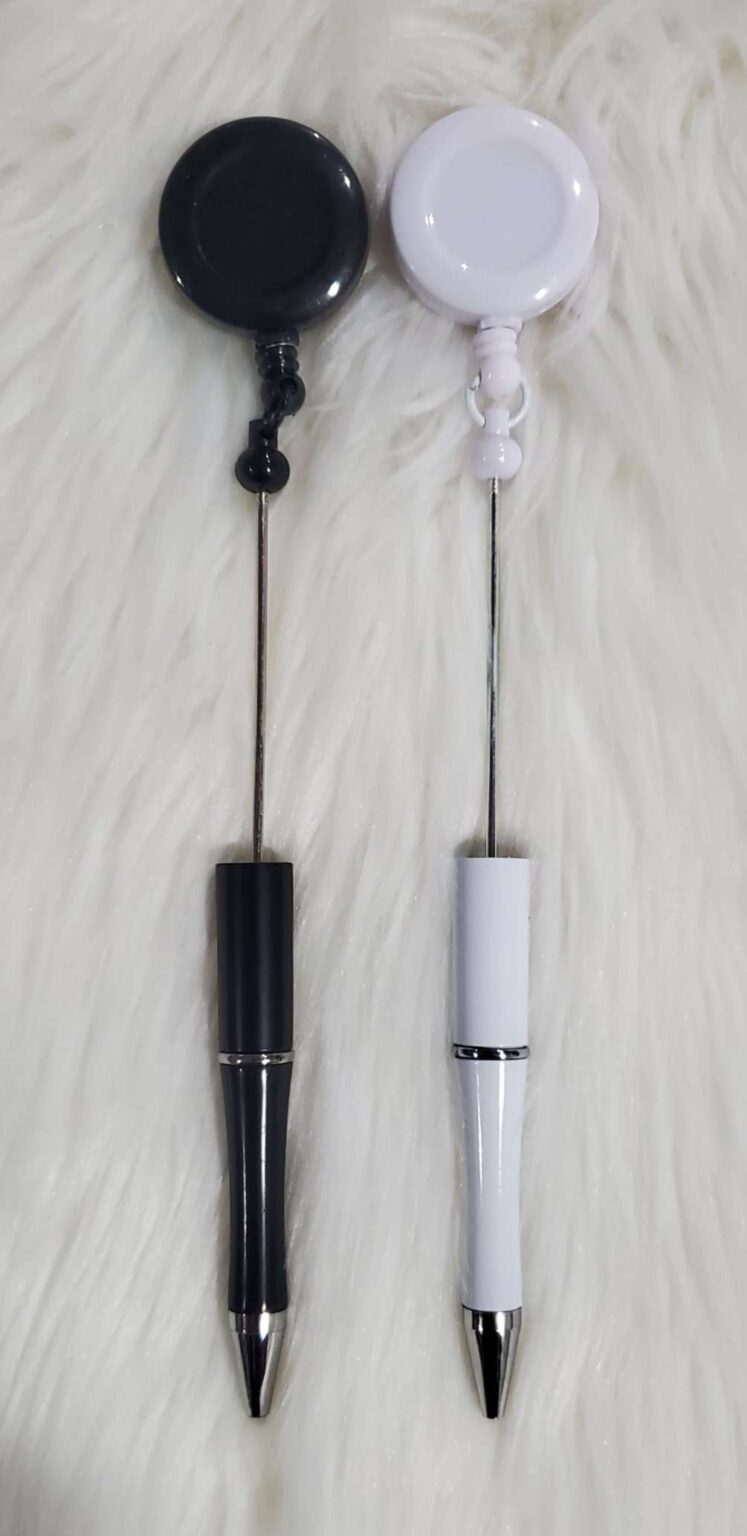 A pair of electronic whisks on top of white fur.